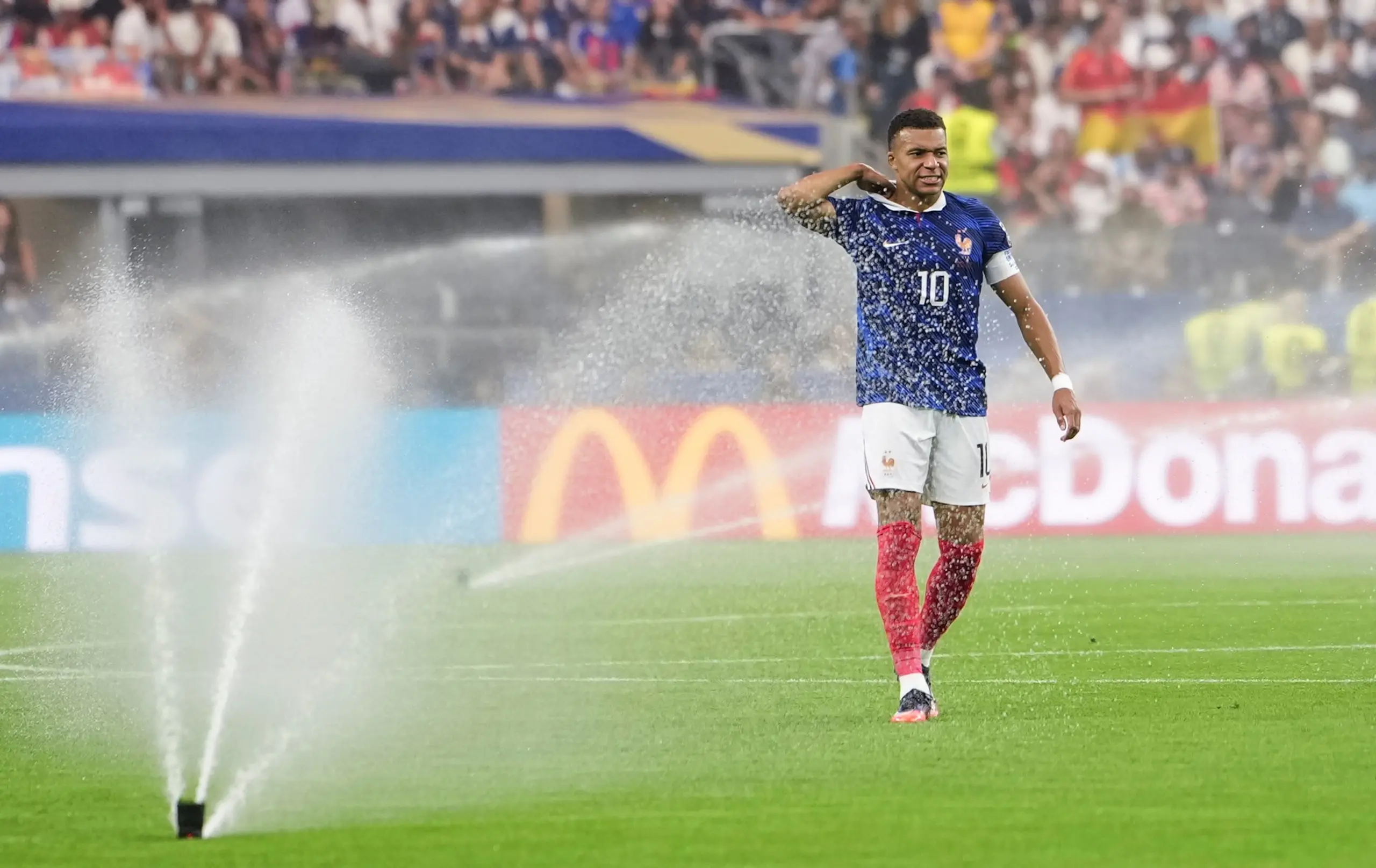 France’s Kylian Mbappé walks on the pitch during a hydration break. 