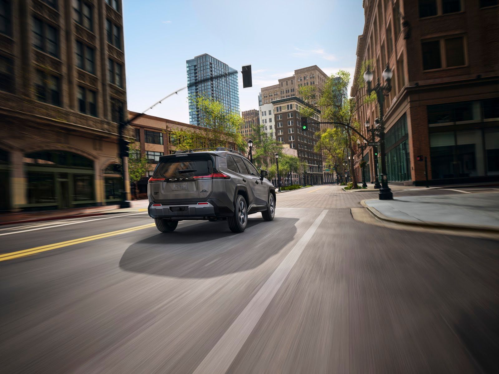 A 2026 Toyota RAV4 drives through an urban area.
