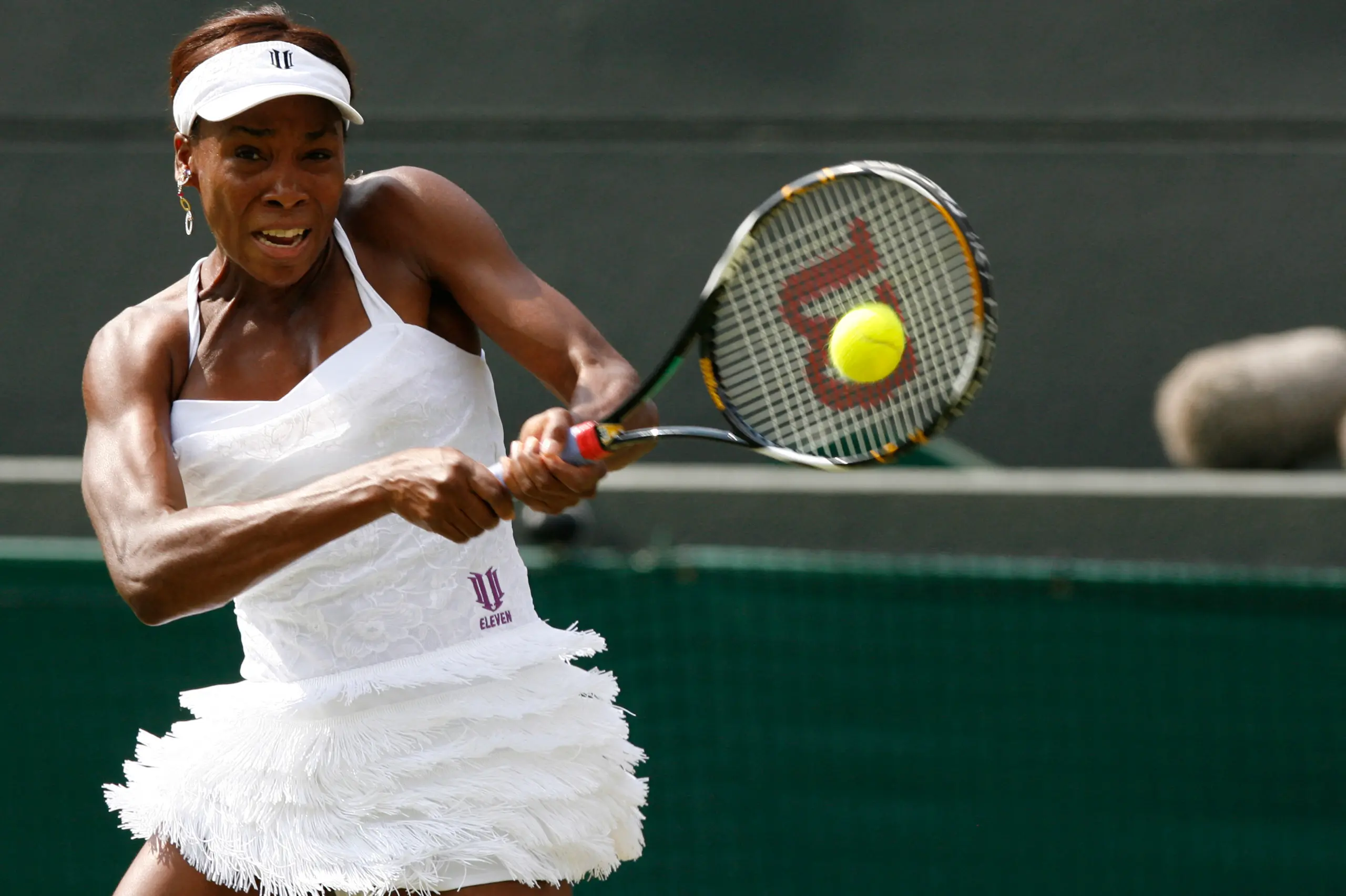 Venus Williams returns a shot at Wimbledon in 2010. 