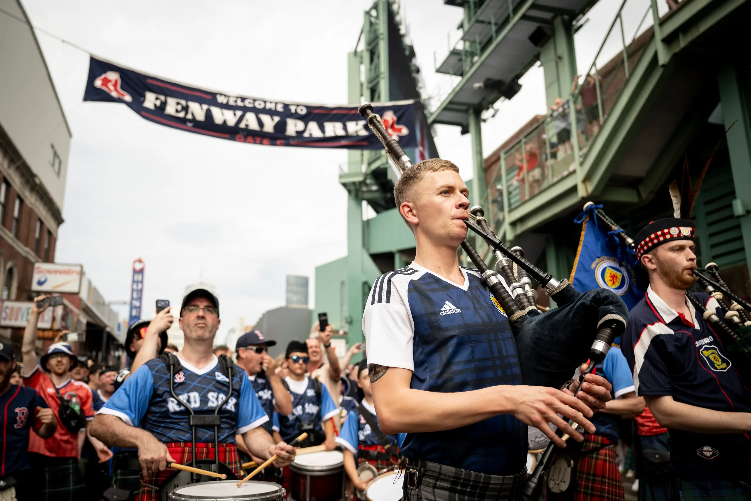 Members of Scotland’s Tartan Army march outside of Fenway Park. 