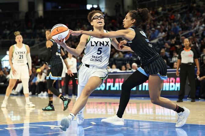 Minnesota Lynx guard Olivia Miles drives to the basket against the Chicago Sky’s Skylar Diggins.