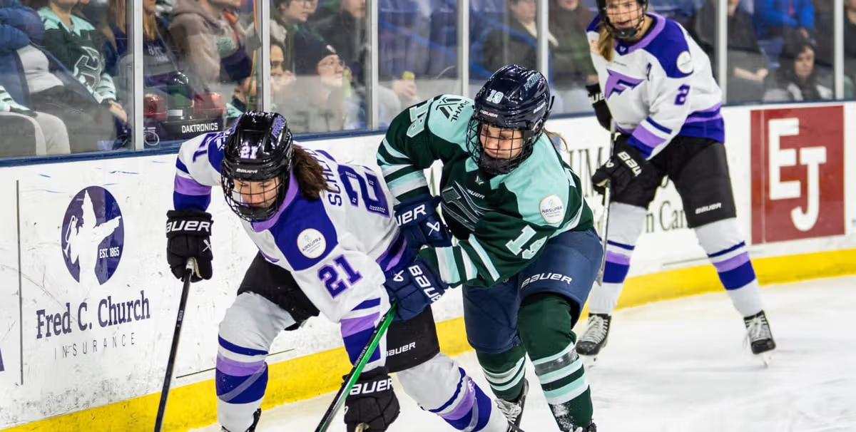 PWHL players battle for the puck 