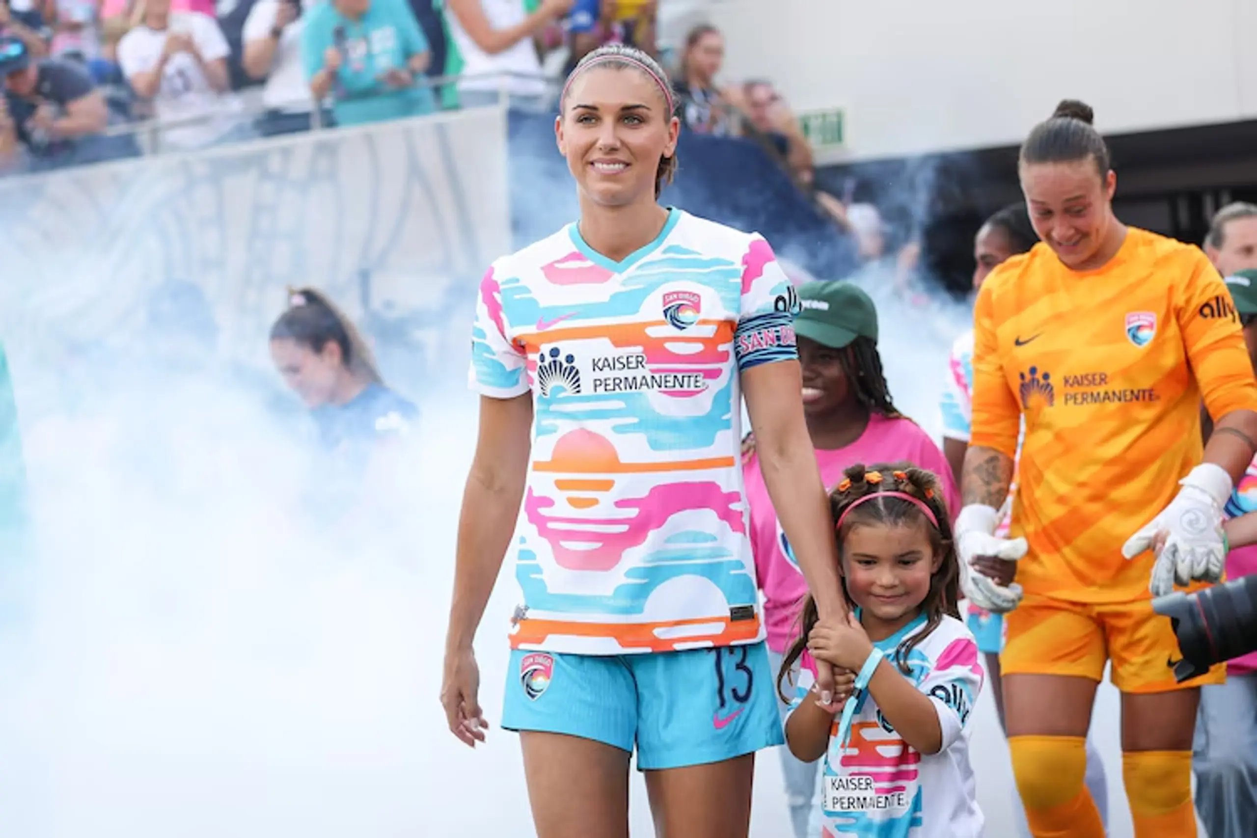 Alex Morgan walks onto the pitch with her daughter, Charlie.