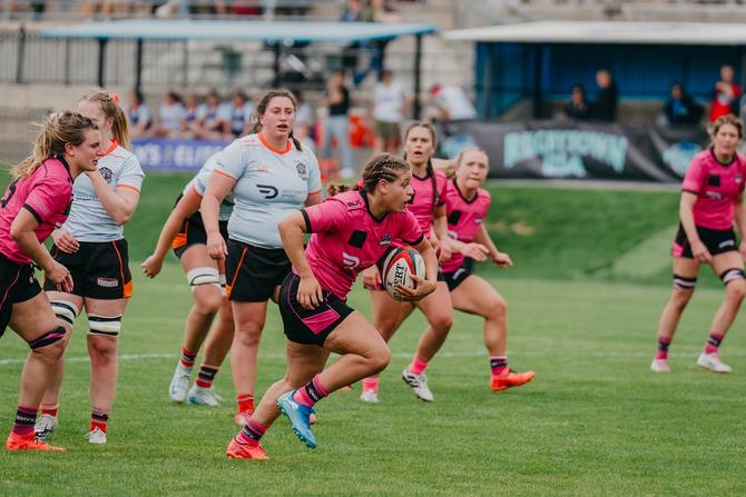 A Denver Onyx player runs the ball during a game.
