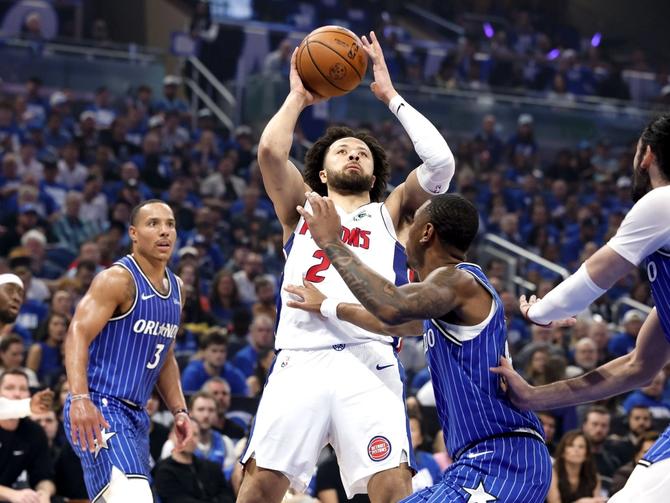 Detroit Piston Cade Cunningham shoots the ball over the Orlando Magic’s Jamal Cain.