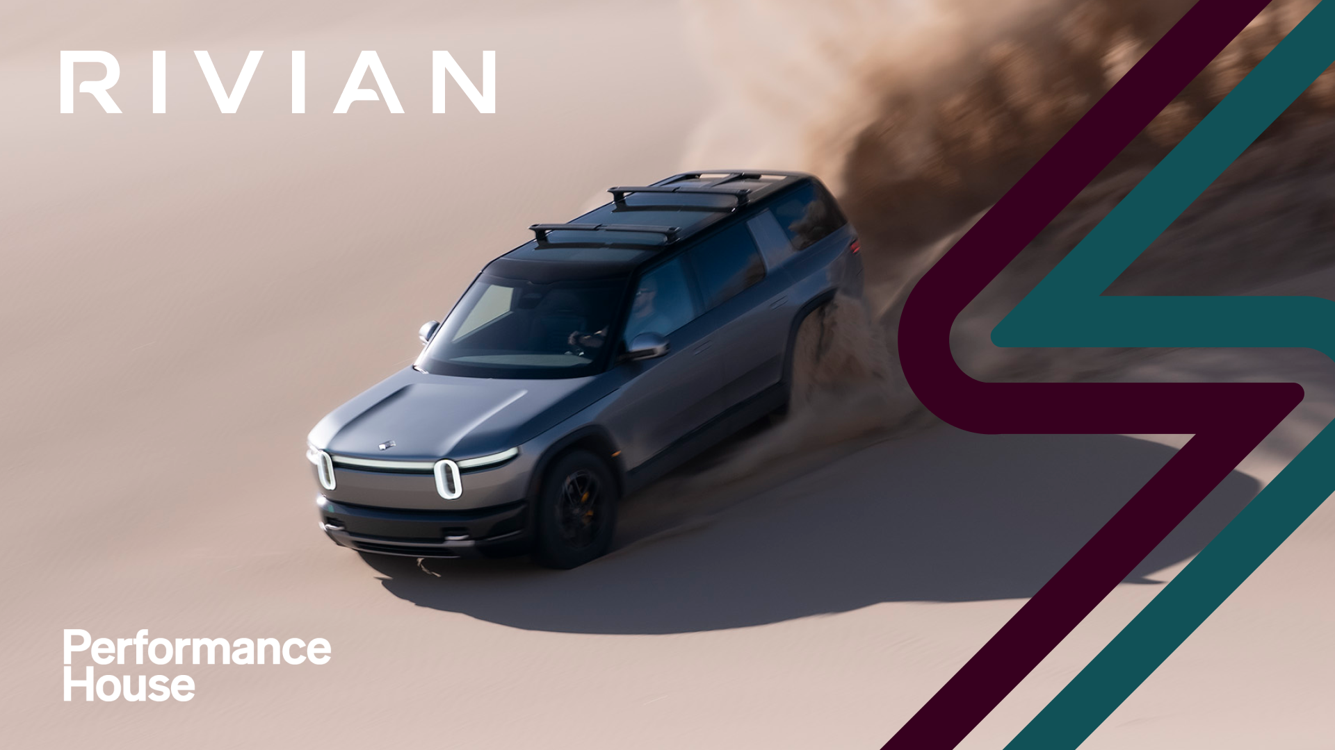 A silver Rivian SUV drives through sand dunes, kicking up a cloud of dust, with Rivian branding and Performance House logo displayed alongside bold graphic accents.