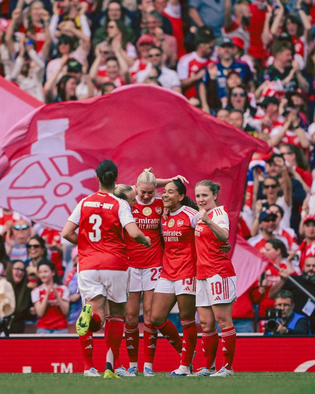 Arsenal players celebrate with Olivia Smith after her goal against OL Lyonnes.
