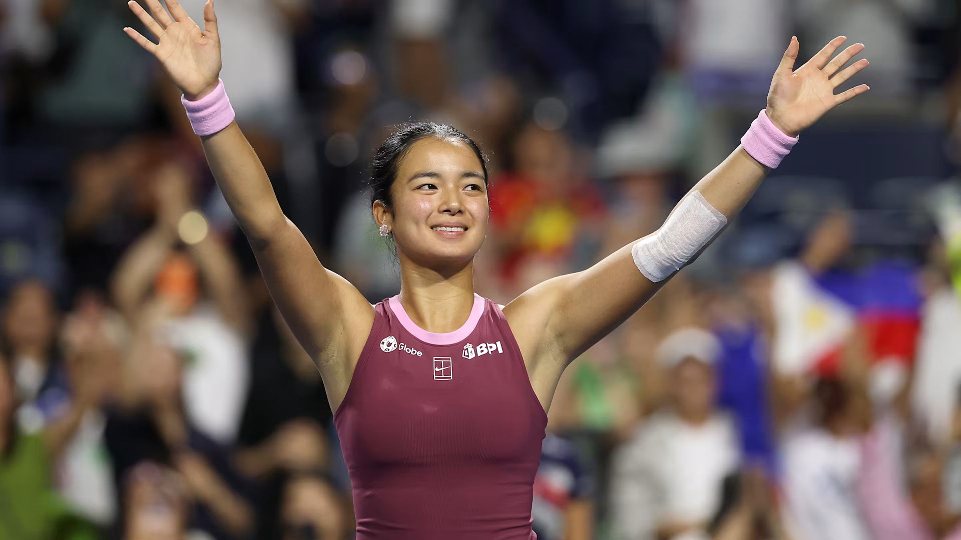 Alex Eala poses with her arms wide open after her win against U.S. competitor Alycia Parks in the Canadian Open.
