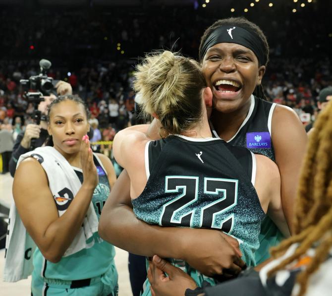 Betnijah Laney-Hamilton #44, Courtney Vandersloot #22 and Jonquel Jones #35 of the New York Liberty celebrate.