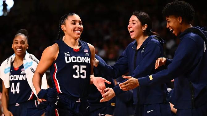 UConn women’s basketball star Azzi Fudd high-fives her teammates.