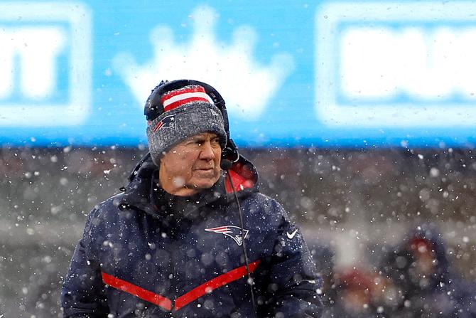 New England Patriots head coach Bill Belichick looks on during a snowy game against the NY Jets.