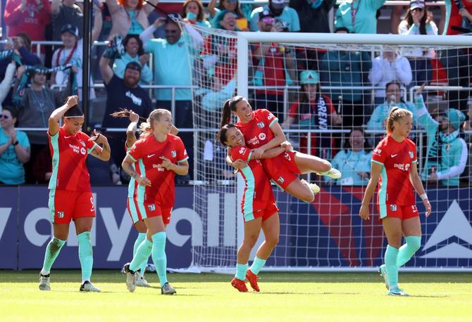 Vanessa DiBernardo #16 of the Kansas City Current is lifted by Lo'eau LaBonta #10 after scoring during the opening match against the Portland Thorns FC at CPKC Stadium