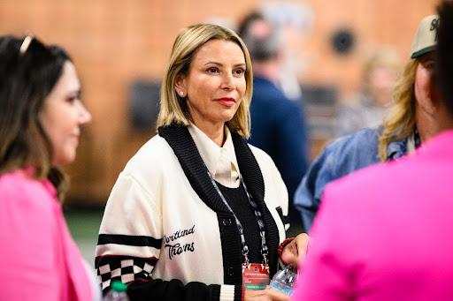 Lisa Bhathal Merage poses in a Portland Thorns jacket.