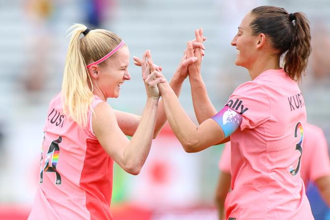 North Carolina Courage forward Tyler Lussi (14) greets North Carolina Courage defender Kaleigh Kurtz (3) after her goal during the NWSL match between the North Carolina Courage and the Chicago Red Stars on June 23, 2024 at WakeMed Soccer Park in Cary, NC.