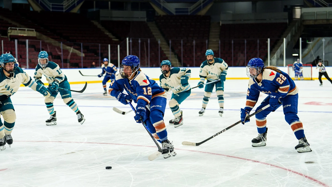 Vancouver Goldeneyes forward Jenn Gardiner skates up this ice with the puck.