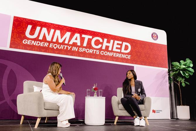 Venus Williams sits on stage while being interviewed by Hazel Mae. The UNMATCHED logo is in the background.