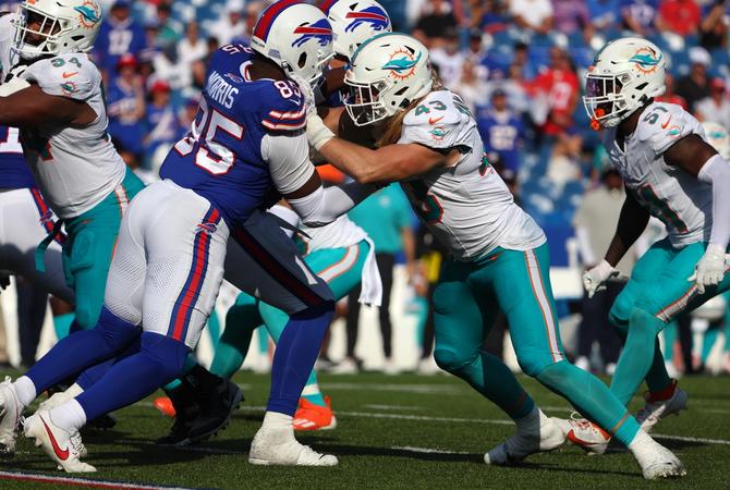 Andrew Van Ginkel of the Miami Dolphins blocks Quintin Morris of the Buffalo Bills.
