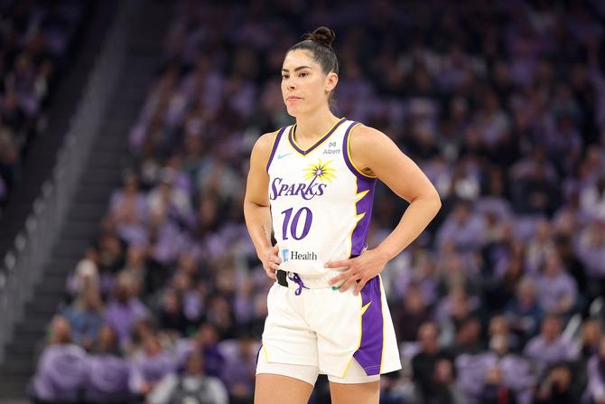 Kelsey Plum looking on with her hands on her hips