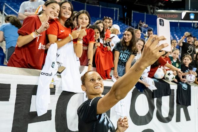 Lynn Williams #10 of NJ/NY Gotham FC takes a selfie with fans at the 2023 FIFA World Cup Send Off before she heads out for the FIFA World Cup and after the National Women’s Soccer League Match against the Chicago Red Stars at Red Bull Arena on June 25, 2023 in Harrison, New Jersey.