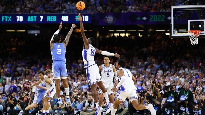 Former UNC guard Caleb Love hits a big shot over former Duke center Mark Williams in their 2022 Final Four matchup, which UNC won 81–77.
