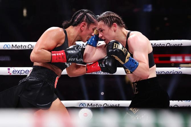 Two women boxing with their heads touching