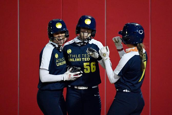 Victoria Hayward #1, Morgan Zerkle #56, and Anissa Urtez #7 of Team Osterman celebrate after scoring in the fifth inning against Team Warren during the final weekend of the Athletes Unlimited softball league at Parkway Bank Sports Complex on September 28, 2020 in Rosemont, Illinois.