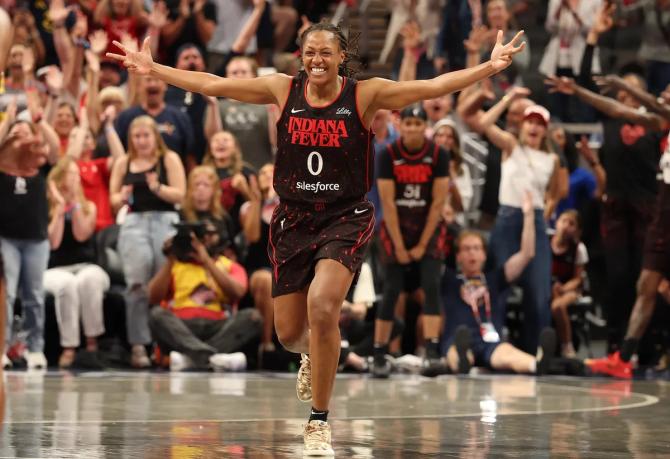 Indiana Fever superstar Kelsey Mitchell celebrates after a Fever basket.