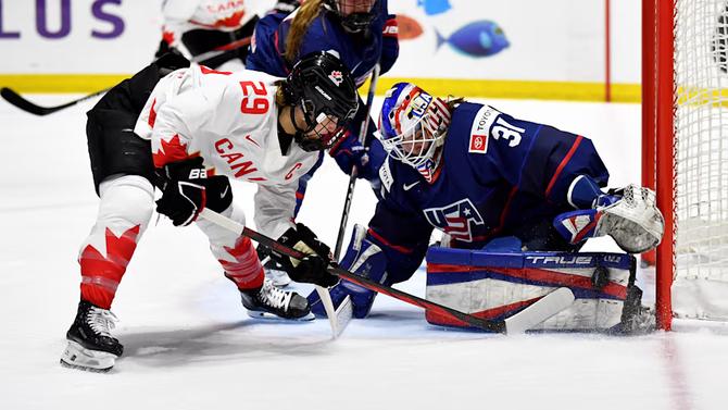 Team Canada takes a shot against Team USA at the 2024 IIHF Women’s World Championship.