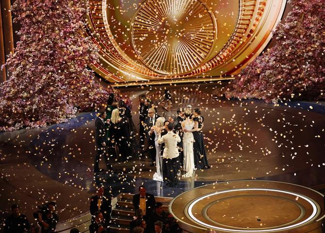 Actors celebrating on the Oscars stage