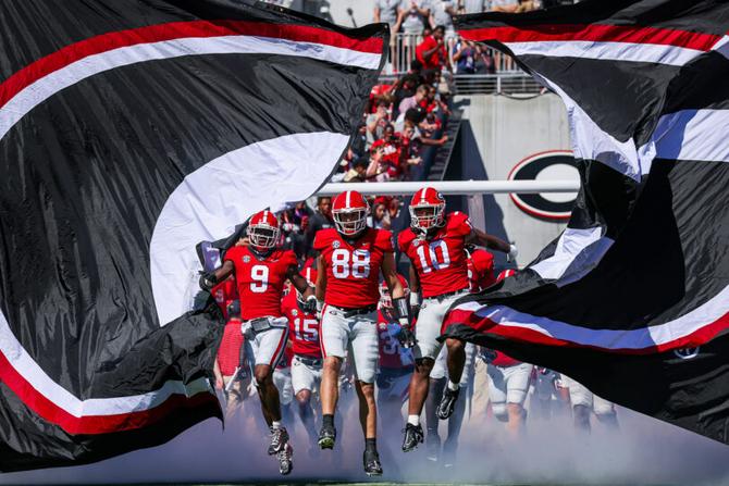 The Georgia football team runs out of the tunnel before a 2022 game.