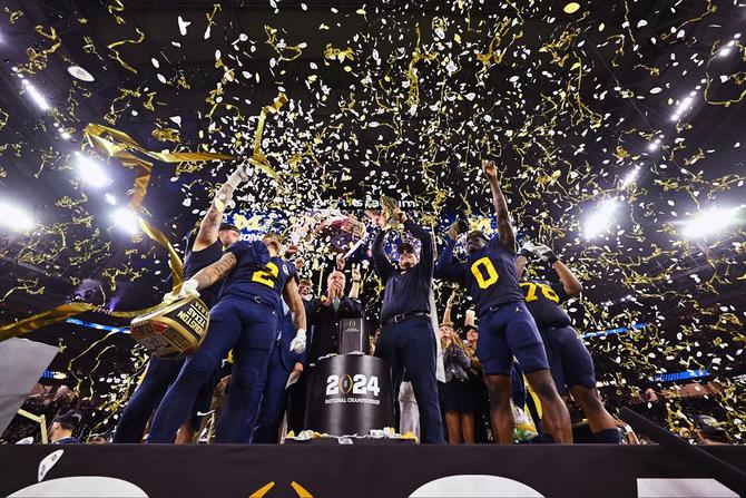 Michigan football celebrates their championship game win as confetti falls.