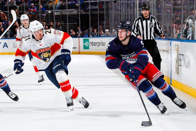 Zac Jones #6 of the New York Rangers skates with the puck against Nick Cousins #21 of the Florida Panthers at Madison Square Garden on March 23, 2024