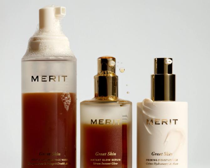 Three bottles of Merit Beauty products on display