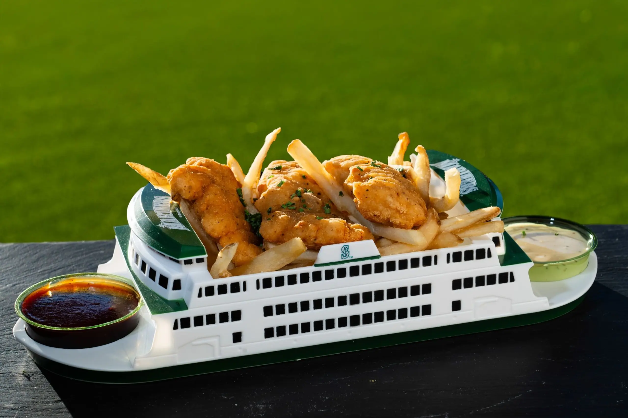 The Seattle Mariners’ ferry boat container, holding chicken tenders and fries with sauce. 