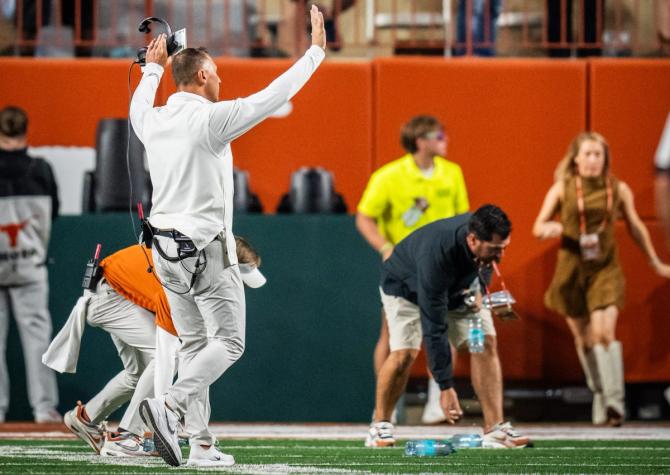 Texas football head coach Steve Sarkisian asks students to stop throwing trash on the field after a controversial call.