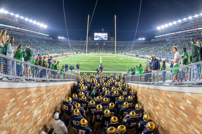 Members of the 2020 Notre Dame football team cluster in their South Bend, Indiana, tunnel before running onto the field.