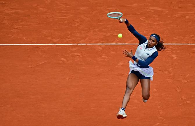 Coco Gauff serves against Elisabetta Cocciaretto in the French Open.