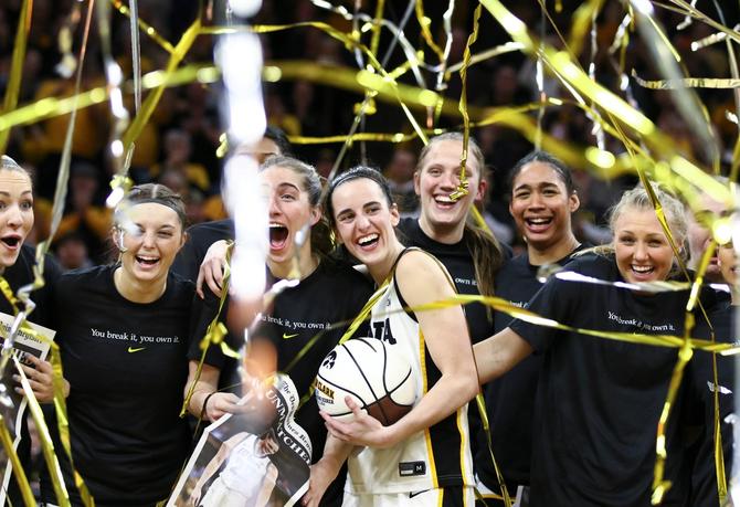 Guard Caitlin Clark #22 of the Iowa Hawkeyes celebrates with teammates during a presentation after breaking the NCAA women's all-time scoring record during the game against the Michigan Wolverines at Carver-Hawkeye Arena on February 15, 2024 in Iowa City, Iowa.