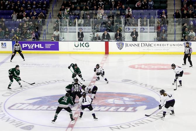Taylor Heise #27 of Minnesota and Alina Müller #11 of Boston compete for the first puck drop of the Inaugural PWHL Boston game