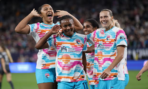 San Diego Wave players gather during a match.