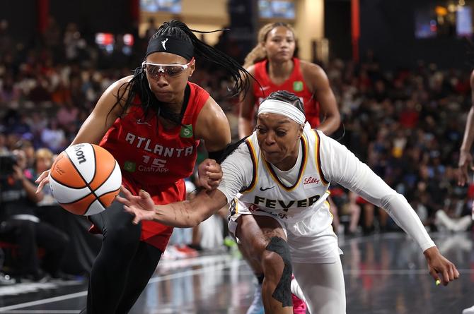 Indiana Fever guard Odyssey Sims fights for the ball against Atlanta Dream guard Allisha Gray.