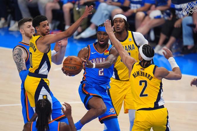 Oklahoma City Thunder’s Shai Gilgeous-Alexander is swarmed by the Indiana Pacers.