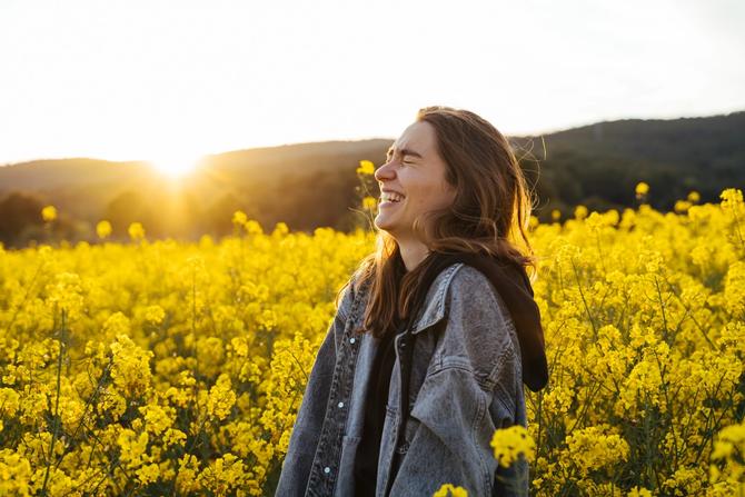 A woman smiling in a field of flowers