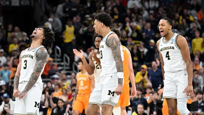 Michigan players celebrate during their Elite Eight win over Tennessee 