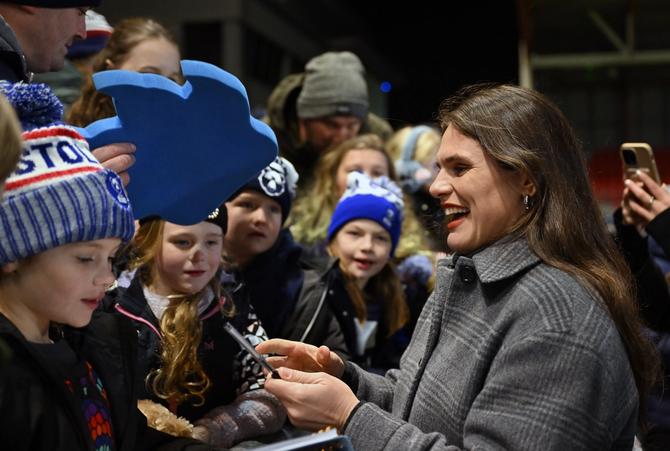 Ilona Maher, the newest member of the Bristol Bears Women, signs autographs for fans during the Investec Champions Cup match between the Bristol Bears and Leinster Rugby at Ashton Gate on December 08, 2024 in Bristol, England.