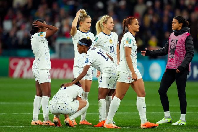 USWNT defender Crystal Dunn comforts a teammate after a disappointing finish at the 2023 FIFA Women’s World Cup.