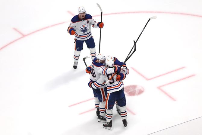 Connor McDavid #97 of the Edmonton Oilers celebrates with teammates after his game winning goal against the Dallas Stars during the second overtime in Game One of the Western Conference Final