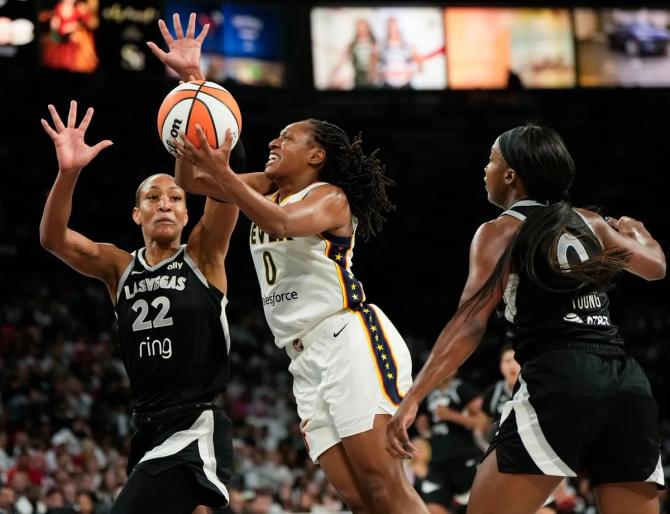 Indiana Fever guard Kelsey Mitchell attempts to score a layup on the Las Vegas Aces.