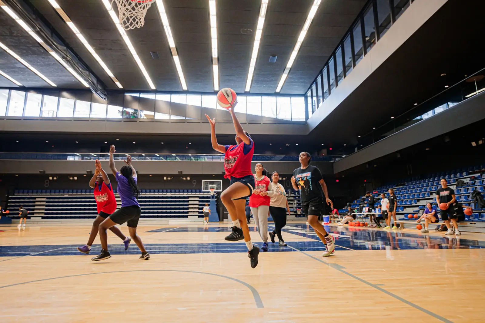 Kids playing basketball at a gym