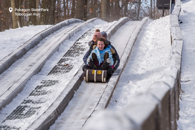 A group of people tobogganing down a hill